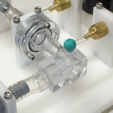 This image shows a fabricated flow testing fixture, used for accurate flow rate testing of medical components